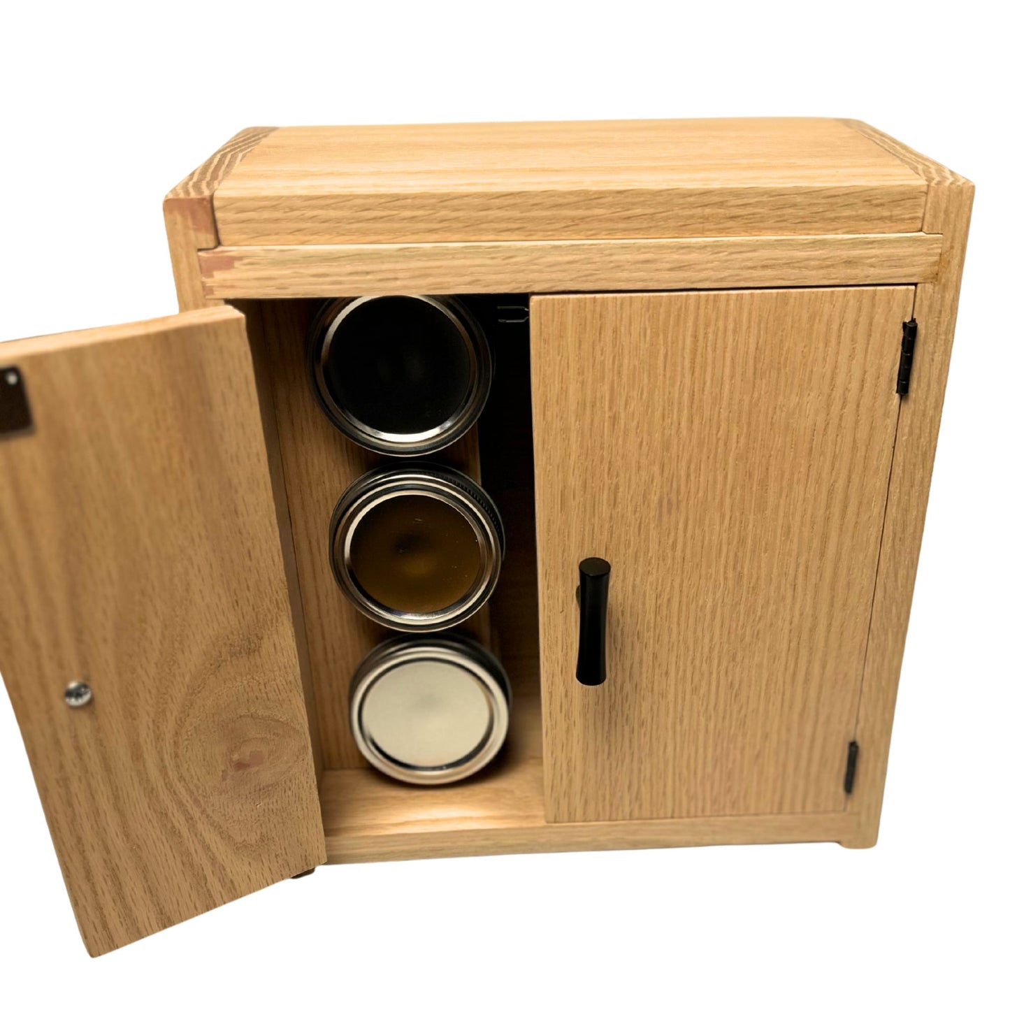 Wooden cabinet with open door revealing metal containers inside on a white background