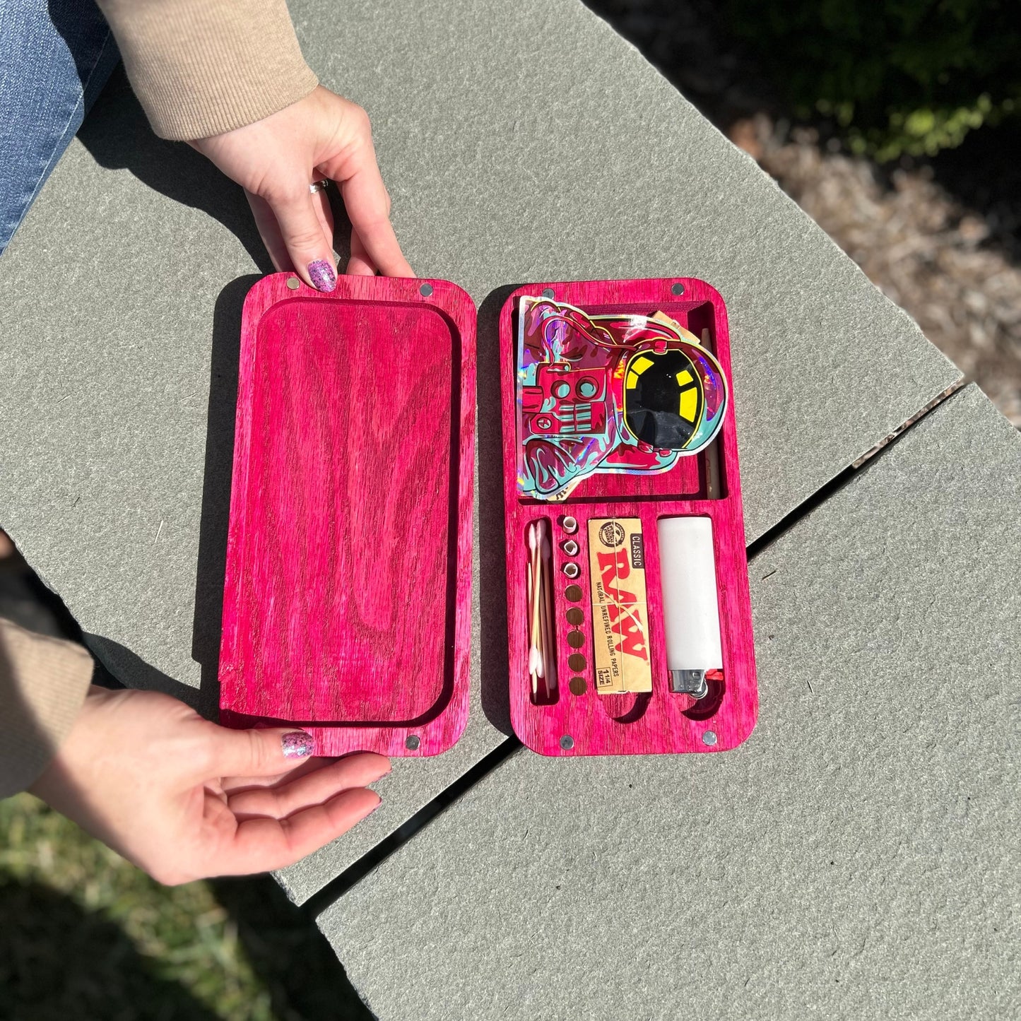 Pink rolling tray with space-themed rolling paper and accessories displayed in a stylish, organized home environment.