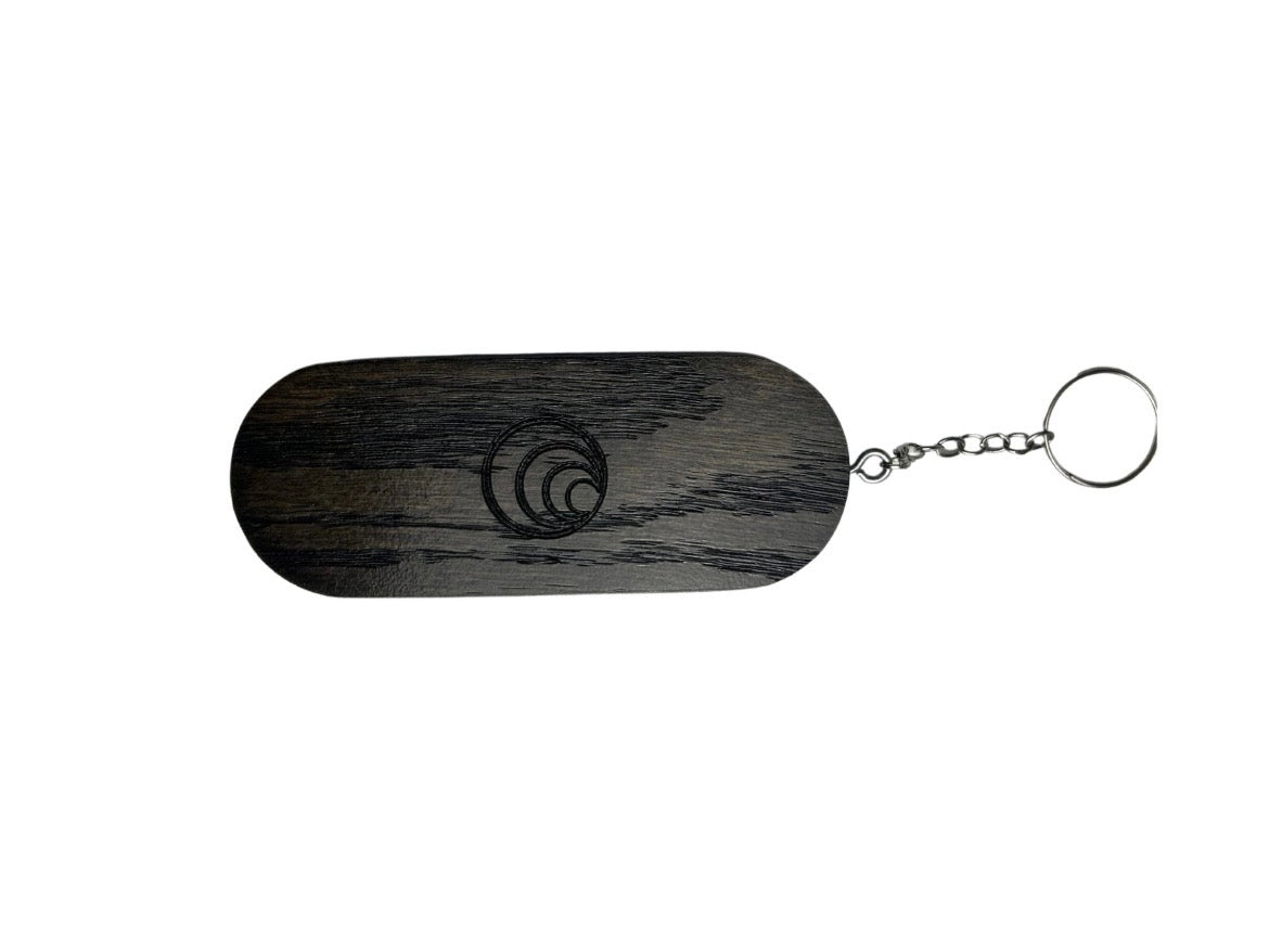 Black wooden keychain with a chain on a white background