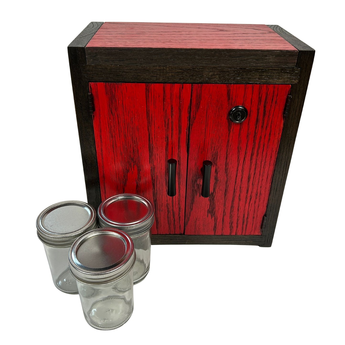 Wooden stash box cabinet with red and black finish and black handles, accompanied by glass jars with metal lids on a white background.