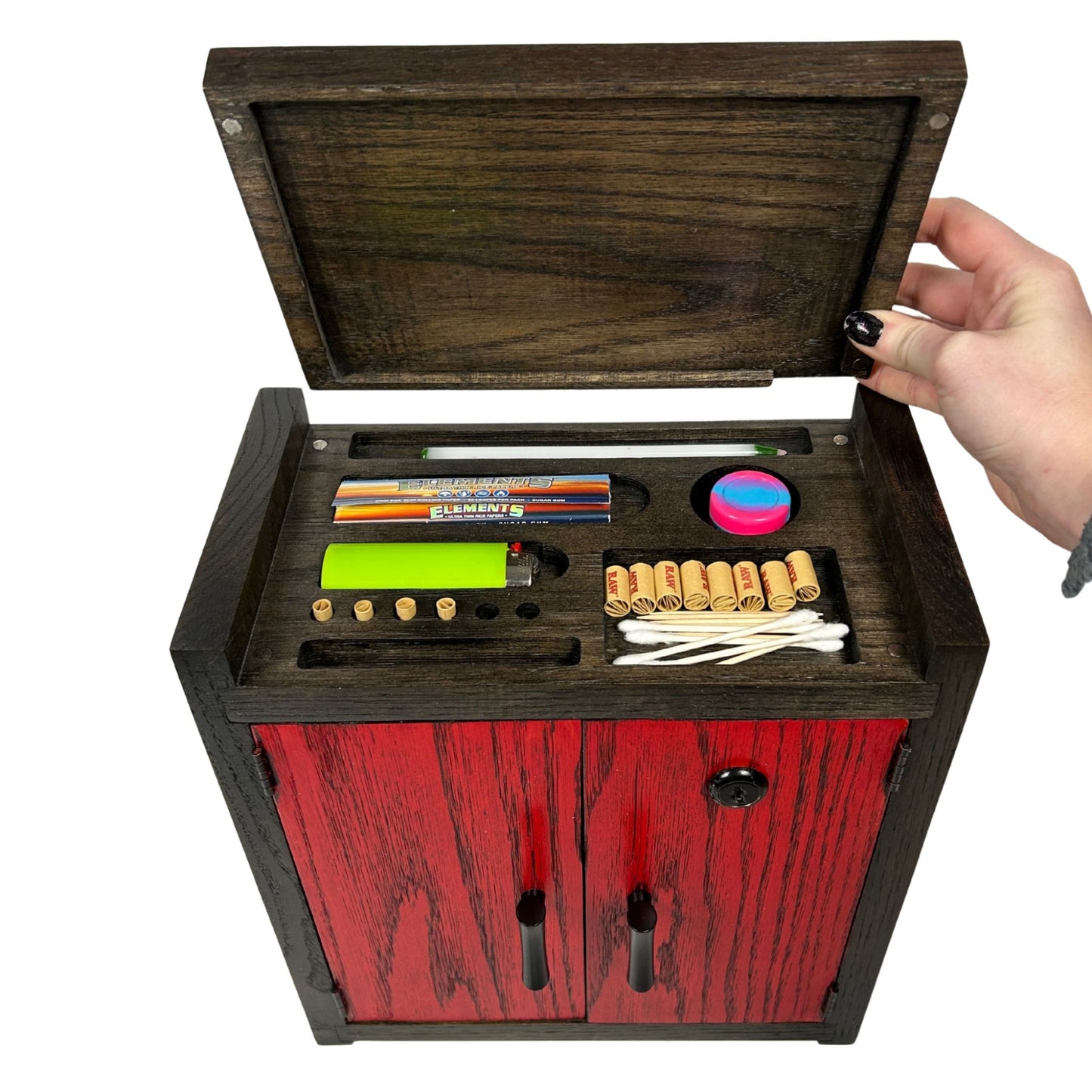 Wooden stash box with red exterior containing stationery items on a white background