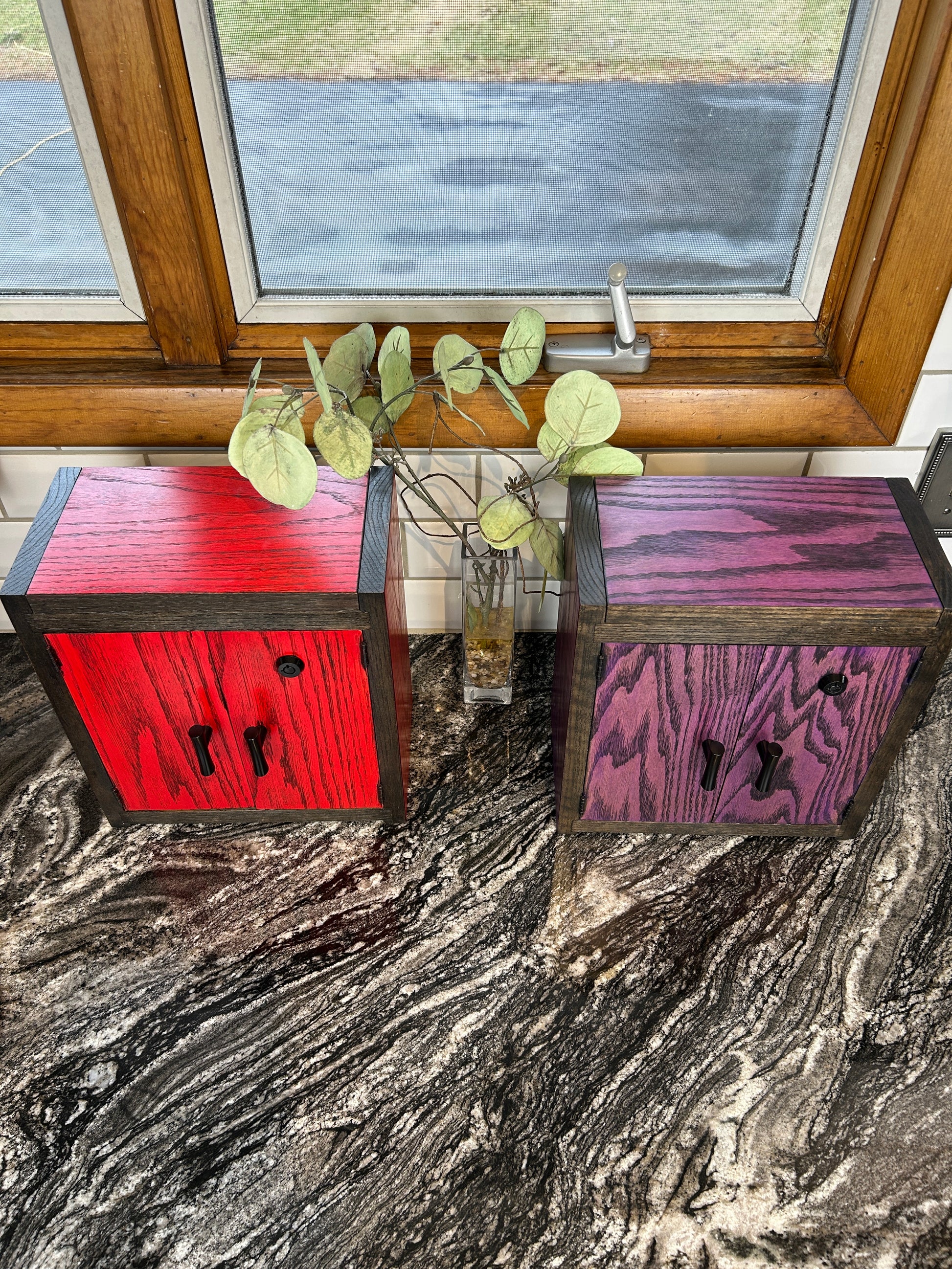 Open Wood Box cabinet revealing multiple glass jars arranged for clean and organized storage.