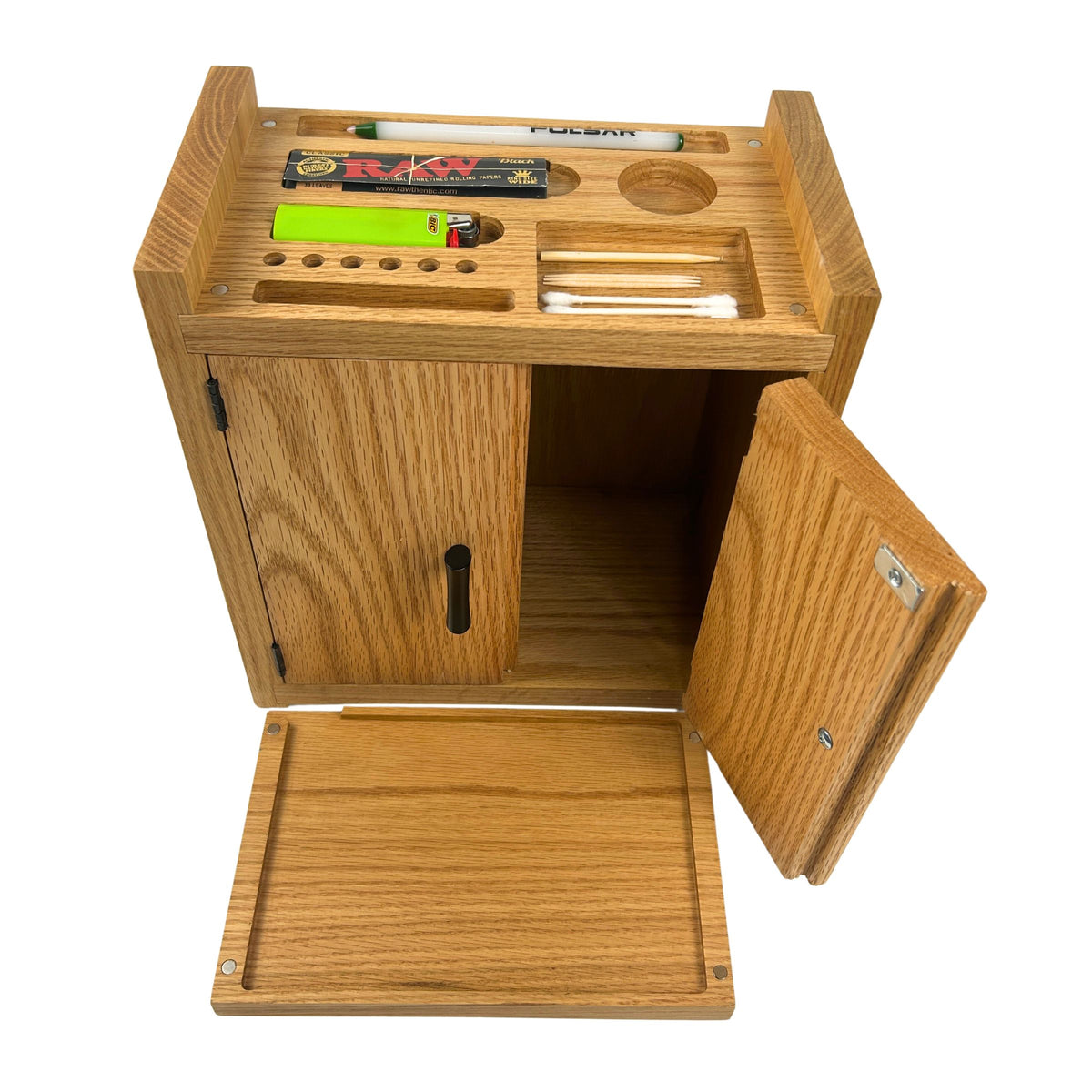 A wooden stash box with an open door and a rolling tray, shown on a white background. The cabinet has a light oak wood grain finish and contains several small accessories, including a lighter, a pen, and cotton swabs.