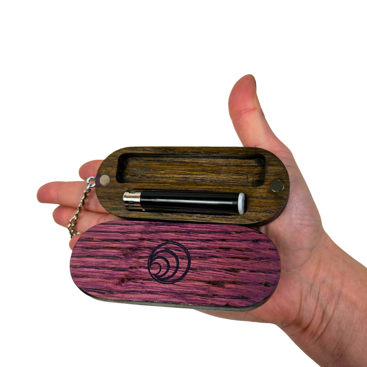 Hand holding a wooden joint case with a lighter