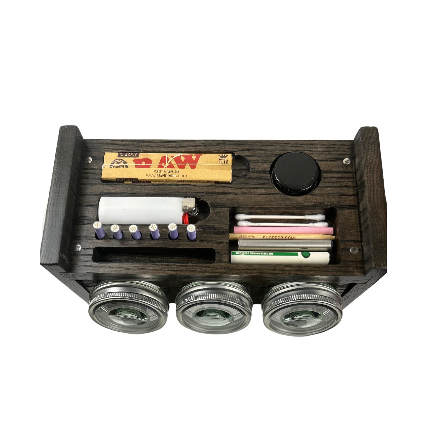 Versatile Usage: The Un Stash Box shown being used to store a variety of smoking accessories, demonstrating its versatility and practicality.